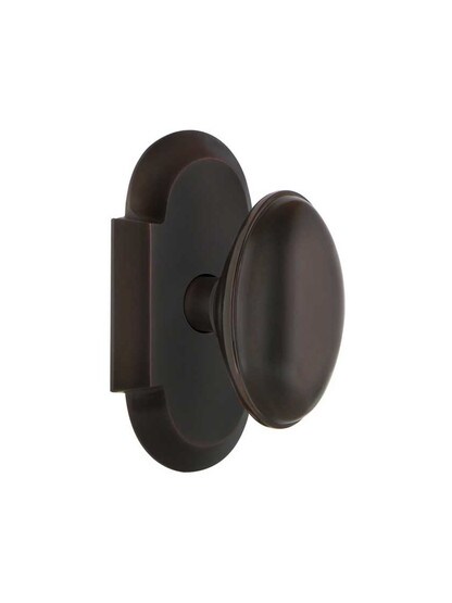 Arched Rosette Door Set with Homestead Knobs in Timeless Bronze.